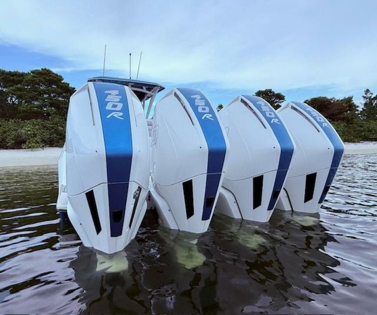 2022 Nor-Tech 390 Sport Center Console with quad 450R outboard engines in shallow water.