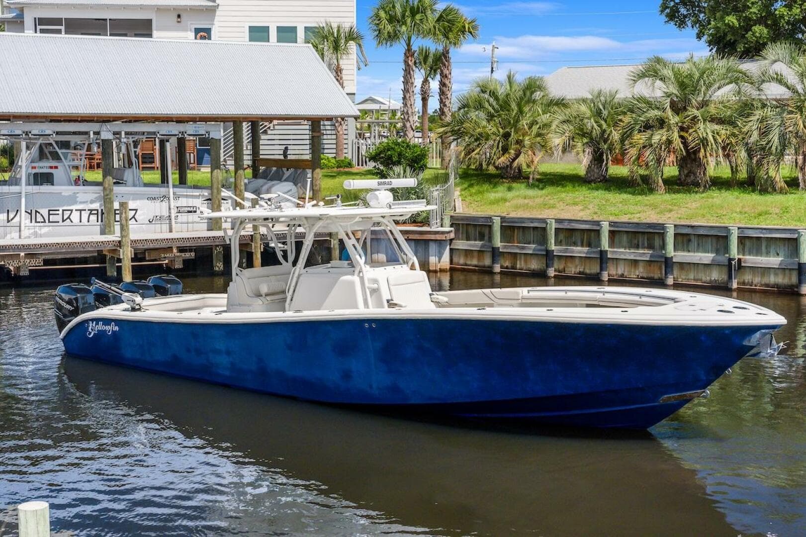 2015 Yellowfin 39 boat docked, featuring a sleek blue hull and spacious deck.