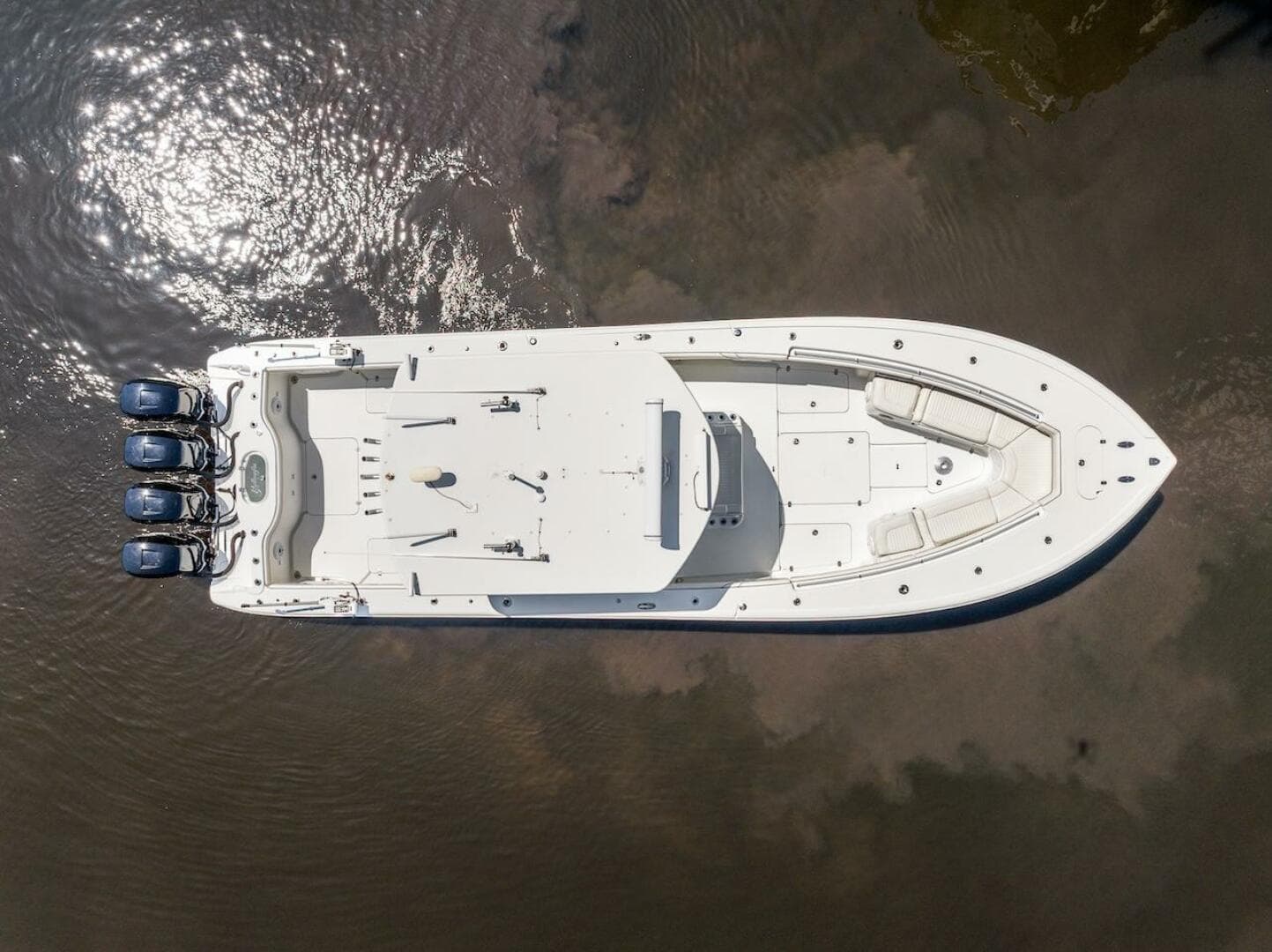 Aerial view of 2015 Yellowfin 39 boat with triple engines on calm water.