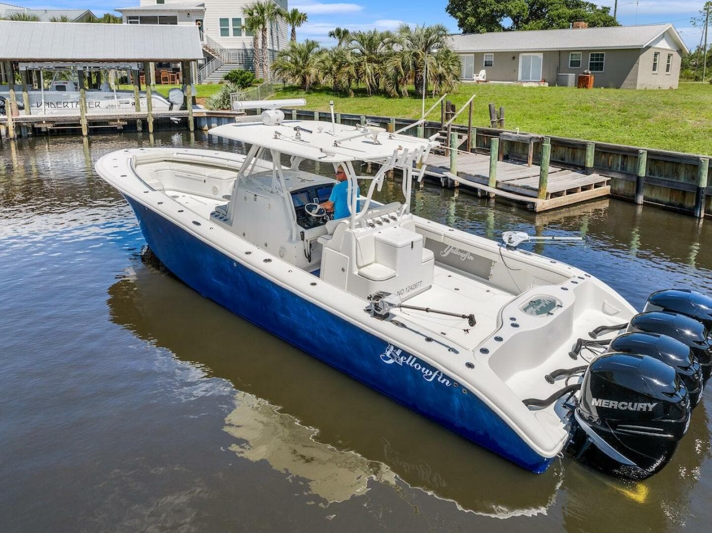 2015 Yellowfin 39 boat with Mercury engines docked in a serene waterfront setting.