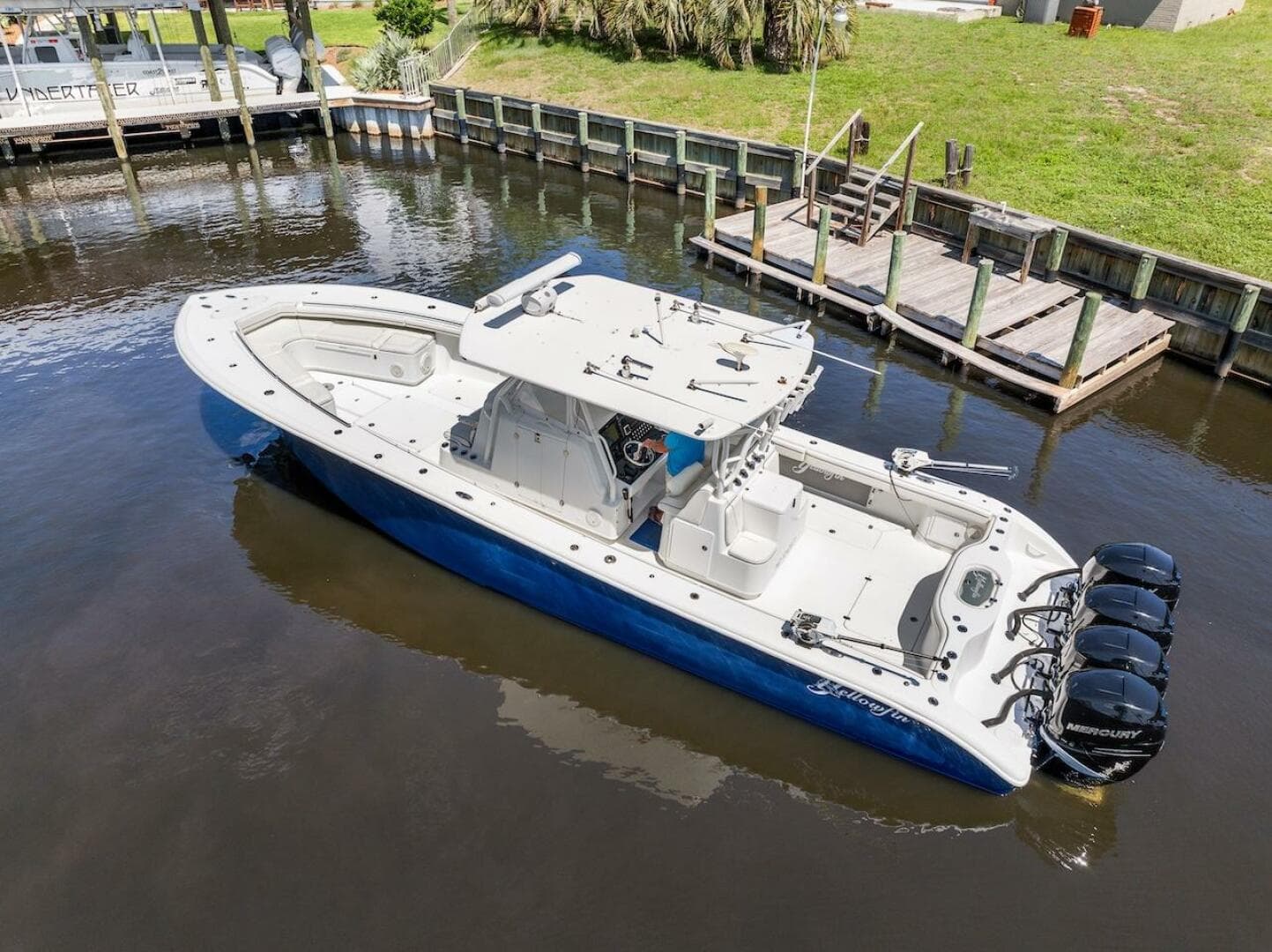 2015 Yellowfin 39 boat with quad Mercury engines docked in a canal.