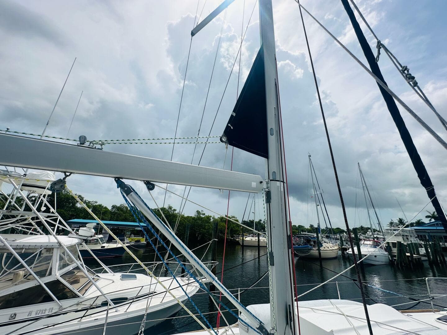Beneteau Oceanis 45 sailboat docked at marina, cloudy sky, 2015 model.