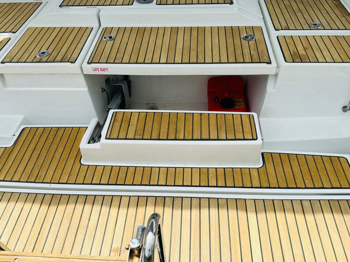 Teak deck of 2015 Beneteau Oceanis 45 sailboat with life raft compartment.