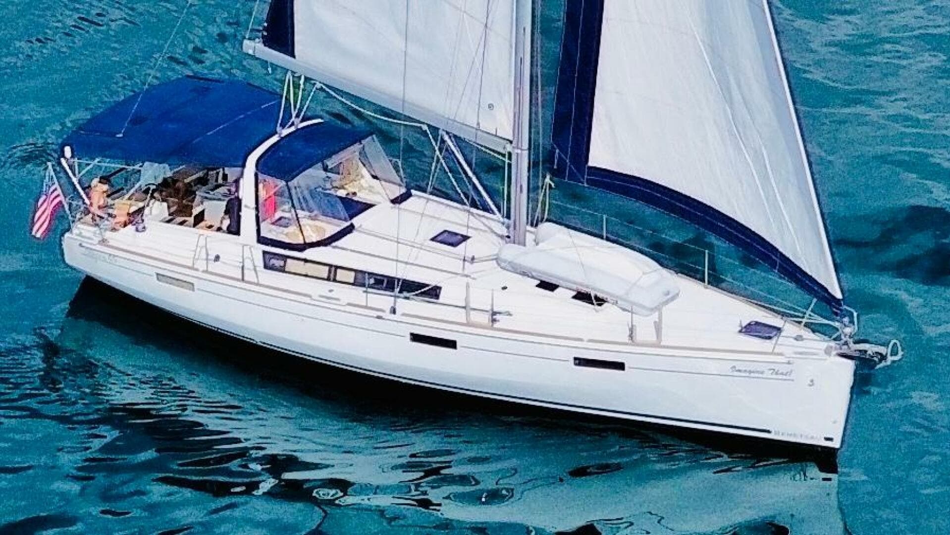 2015 Beneteau Oceanis 45 sailboat cruising on clear blue water.