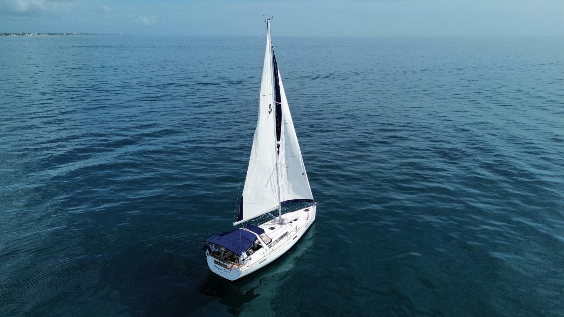 Sailing yacht Beneteau Oceanis 45, 2015 model, cruising on calm blue waters.