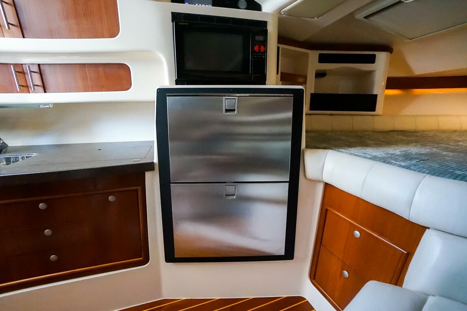 Interior of 2007 Grady-White Express 360 boat with modern kitchen and cozy seating area.