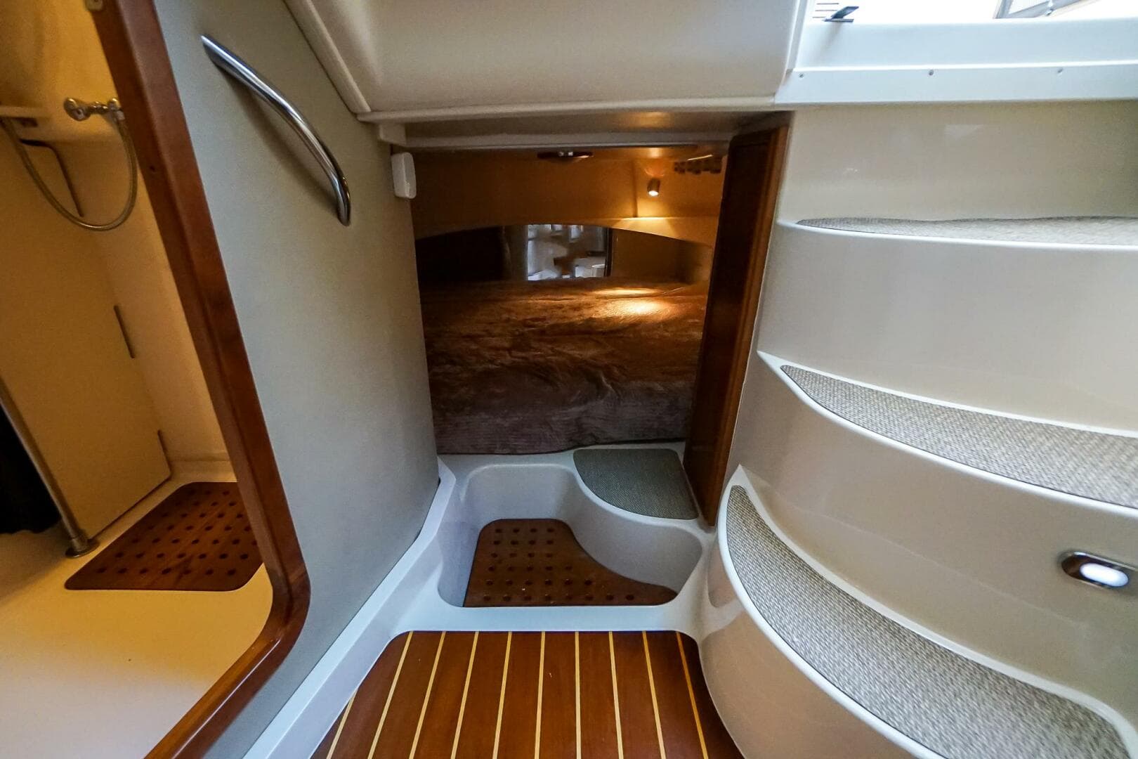 2007 Grady-White Express 360 cabin interior with stairs and cozy sleeping area.