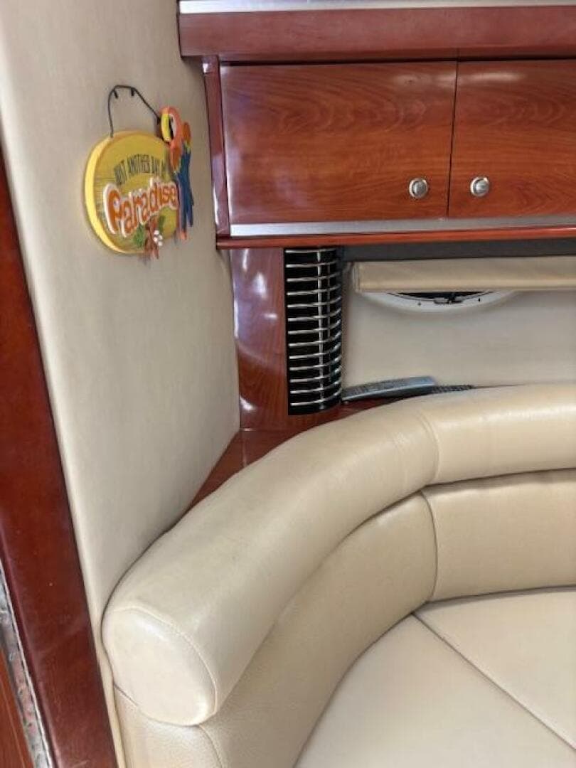 Interior of 2007 Monterey 350 Sport Yacht with beige seating and wooden cabinetry.