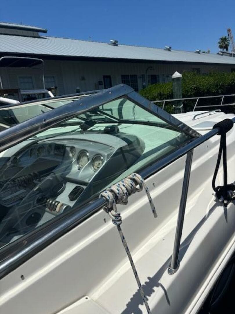 2007 Monterey 350 Sport Yacht with sleek dashboard and mooring rope, docked under clear blue sky.
