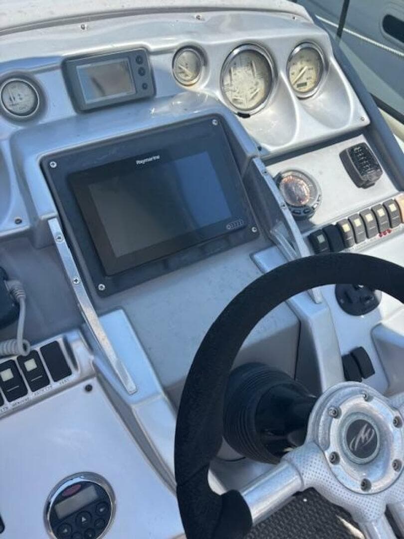Control panel of a 2007 Monterey 350 Sport Yacht with steering wheel and gauges.