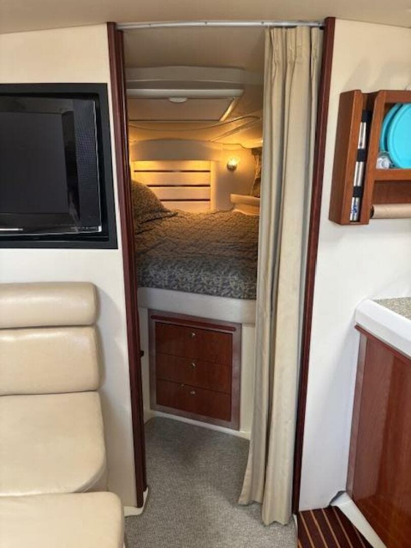 Interior of 2007 Monterey 350 Sport Yacht with cozy bedroom and modern amenities.