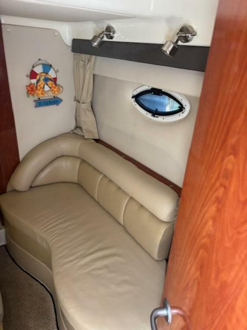 Interior of 2007 Monterey 350 Sport Yacht with beige leather seating and porthole window.