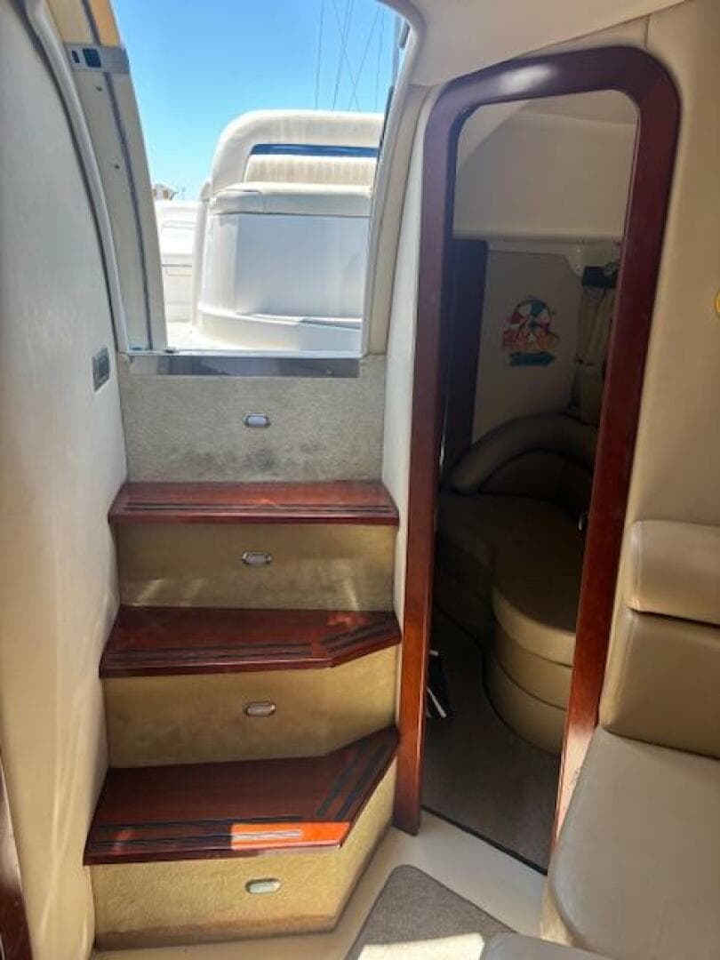 Interior view of a 2007 Monterey 350 Sport Yacht with wooden steps and cozy cabin.