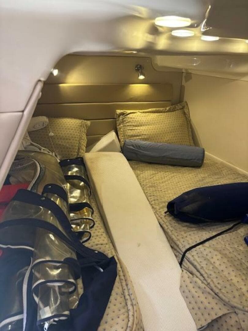 2007 Monterey 350 Sport Yacht cabin interior with cozy bedding and ambient lighting.