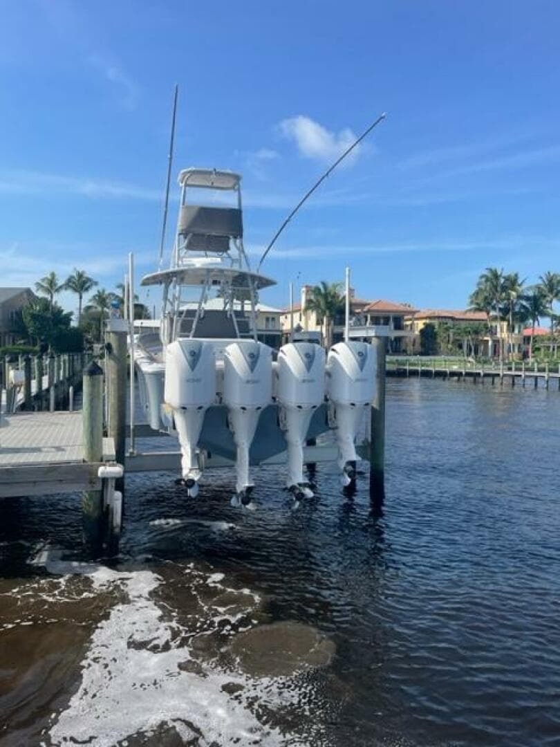 2018 Regulator 41 boat with four engines docked by waterfront homes.