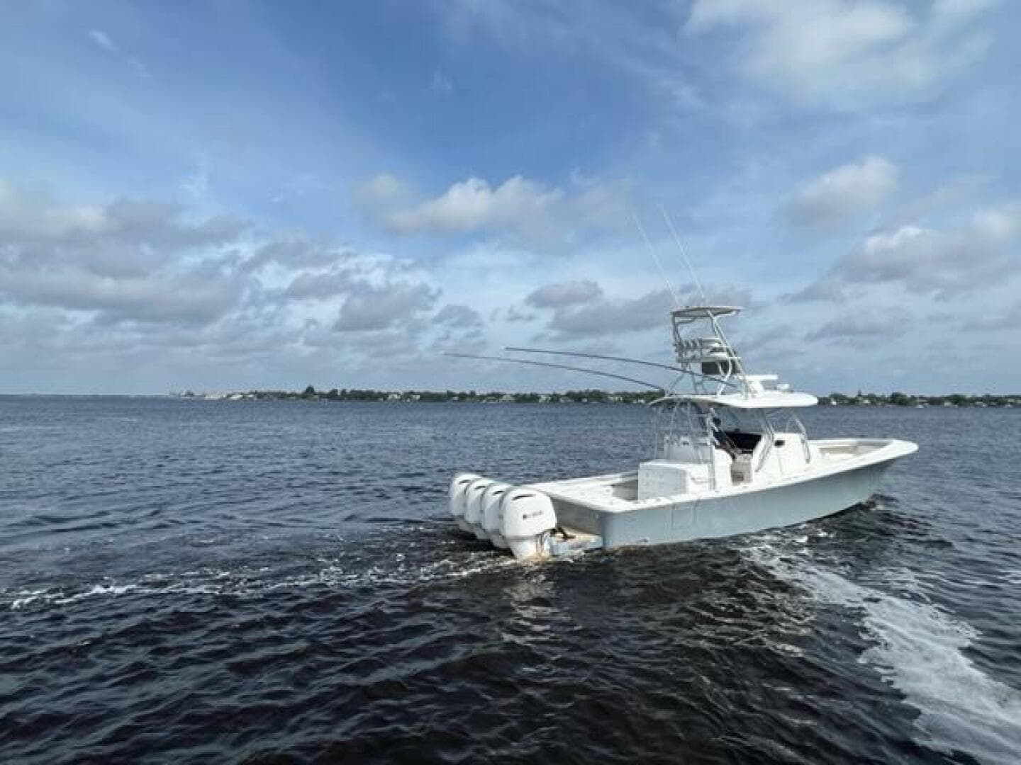 2018 Regulator 41 boat cruising on open water under a partly cloudy sky.