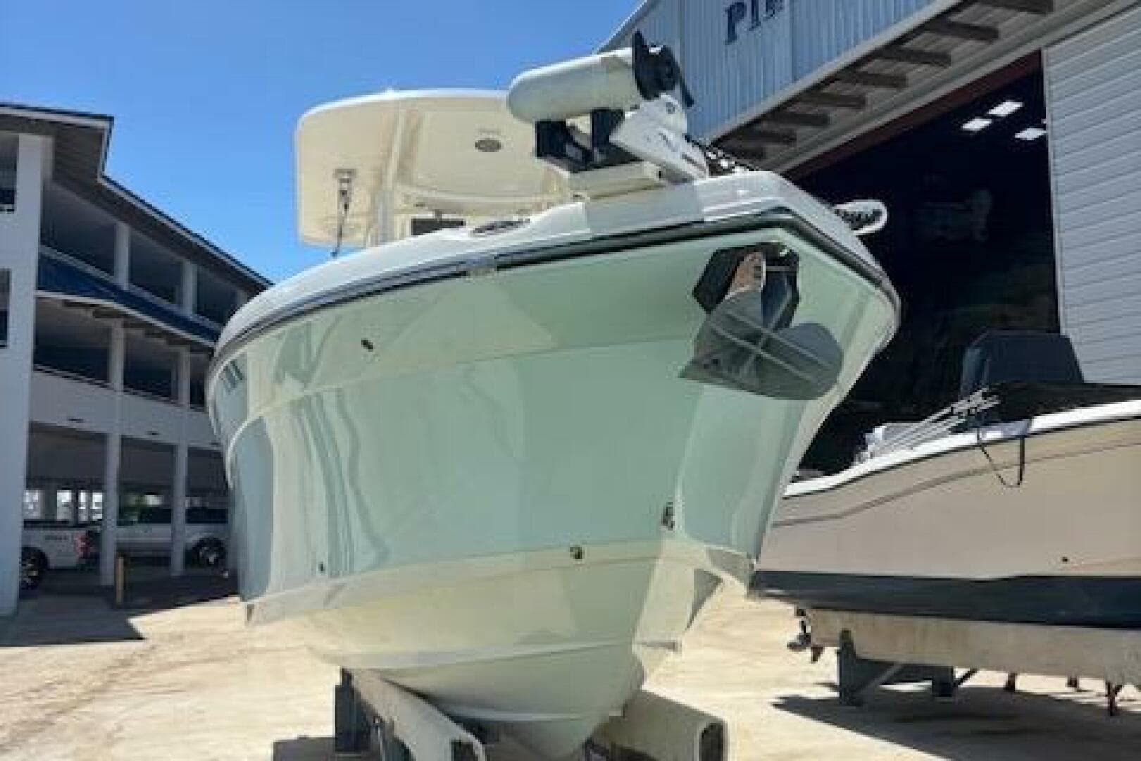 2018 Century 2600 Center Console boat docked at a marina.