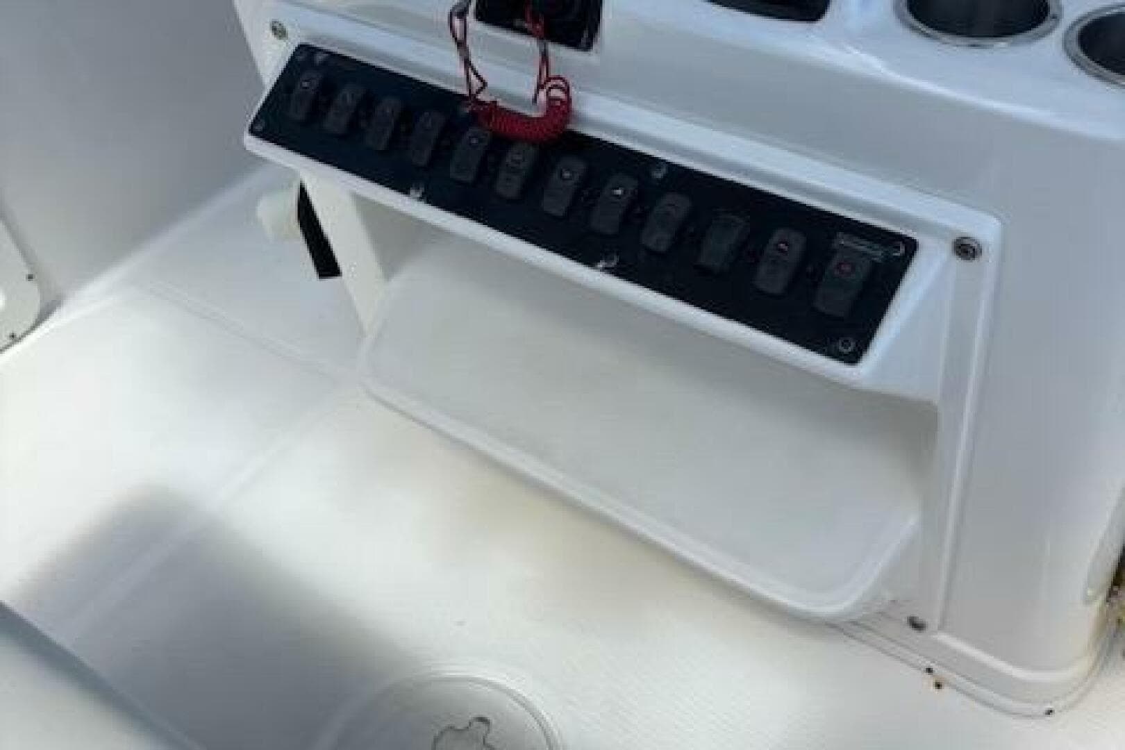 Century 2600 Center Console 2018 boat dashboard with control panel and cup holders.