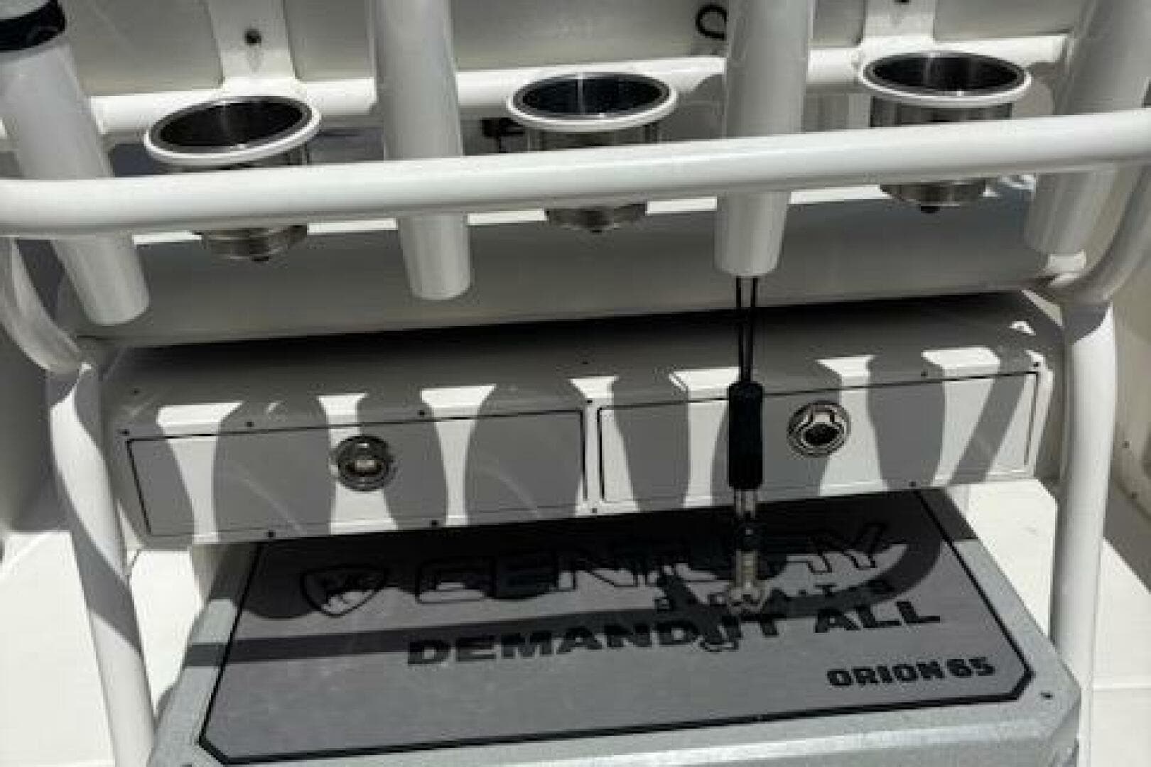 2018 Century 2600 Center Console boat with rod holders and storage compartments.