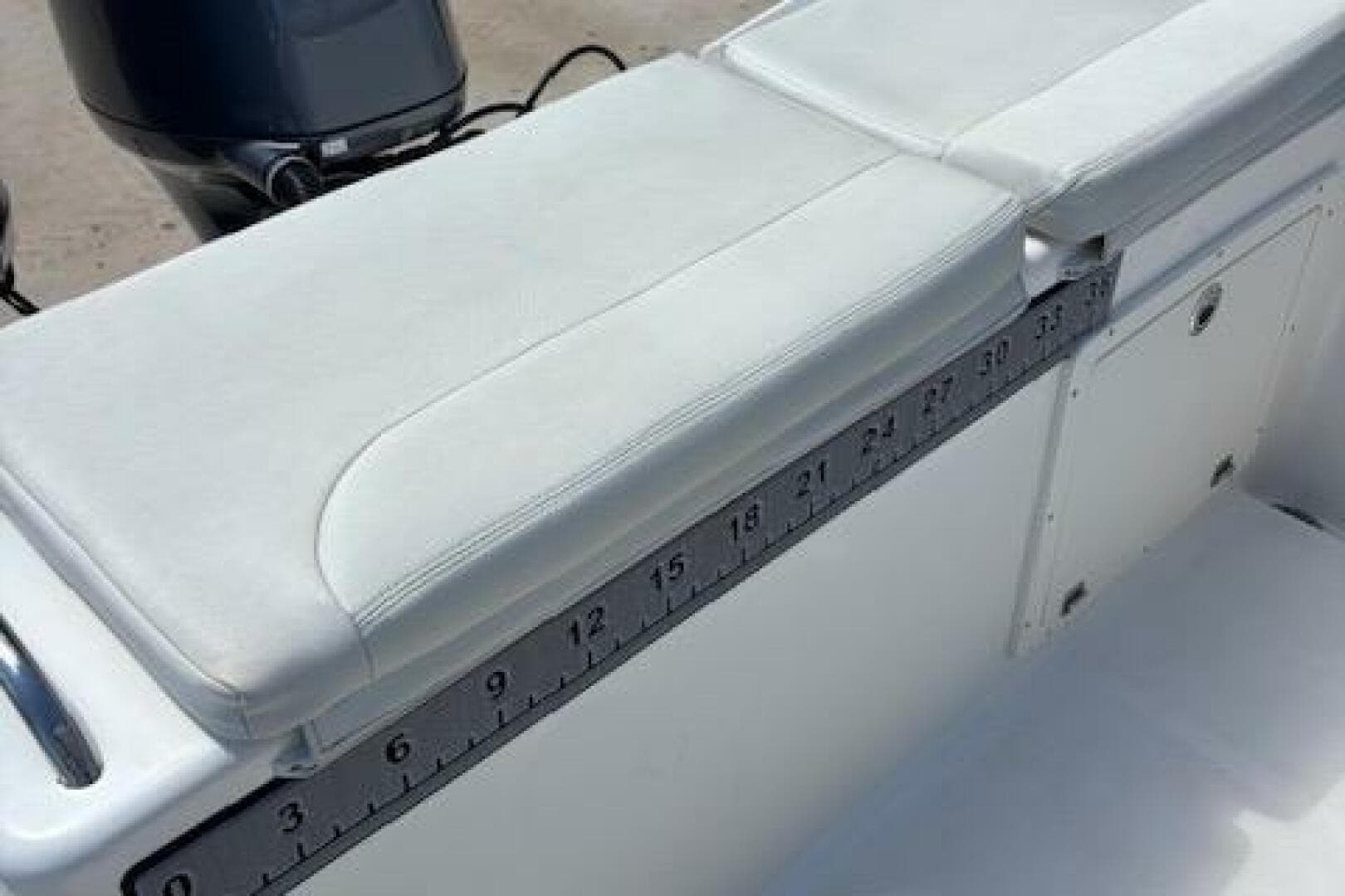 2018 Century 2600 Center Console boat with cushioned seating and built-in measuring ruler.