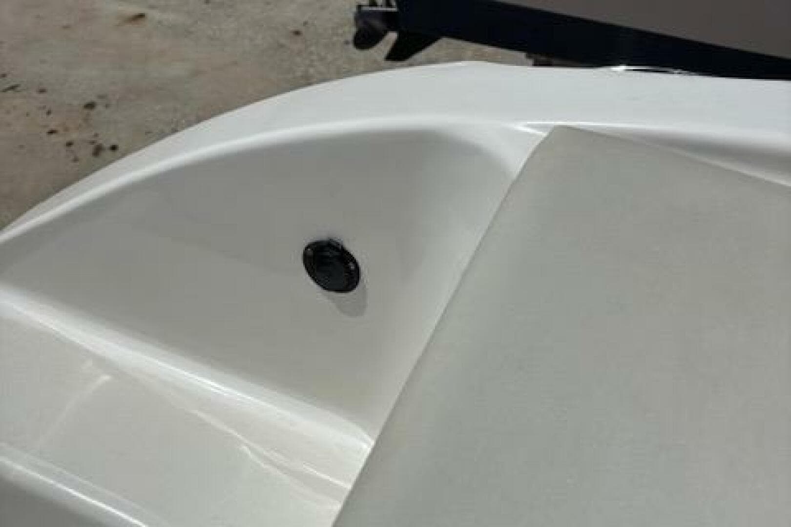 2018 Century 2600 Center Console boat detail, featuring sleek white surface and hardware.