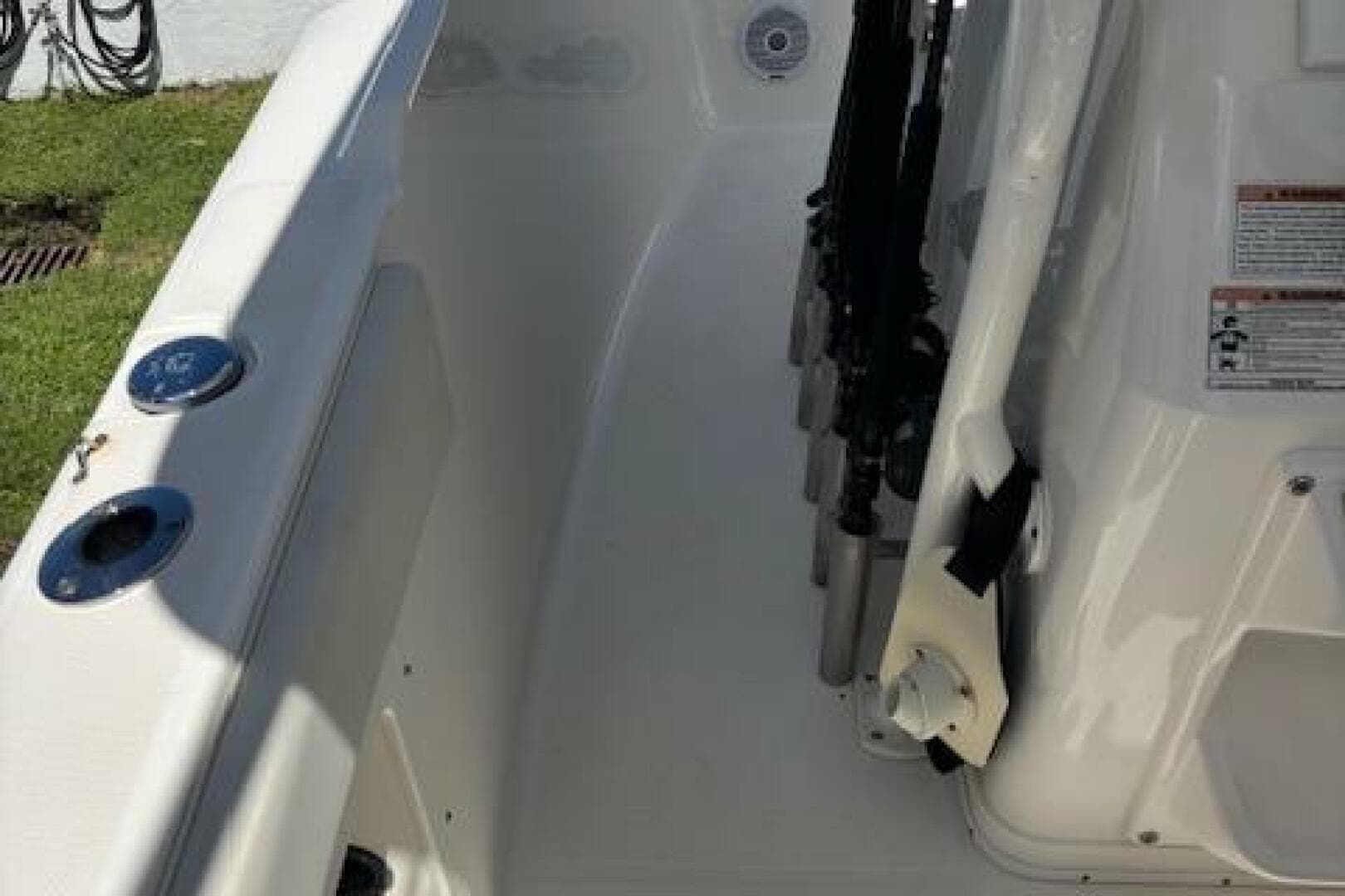 2018 Century 2600 Center Console boat interior with rod holders and seating area.