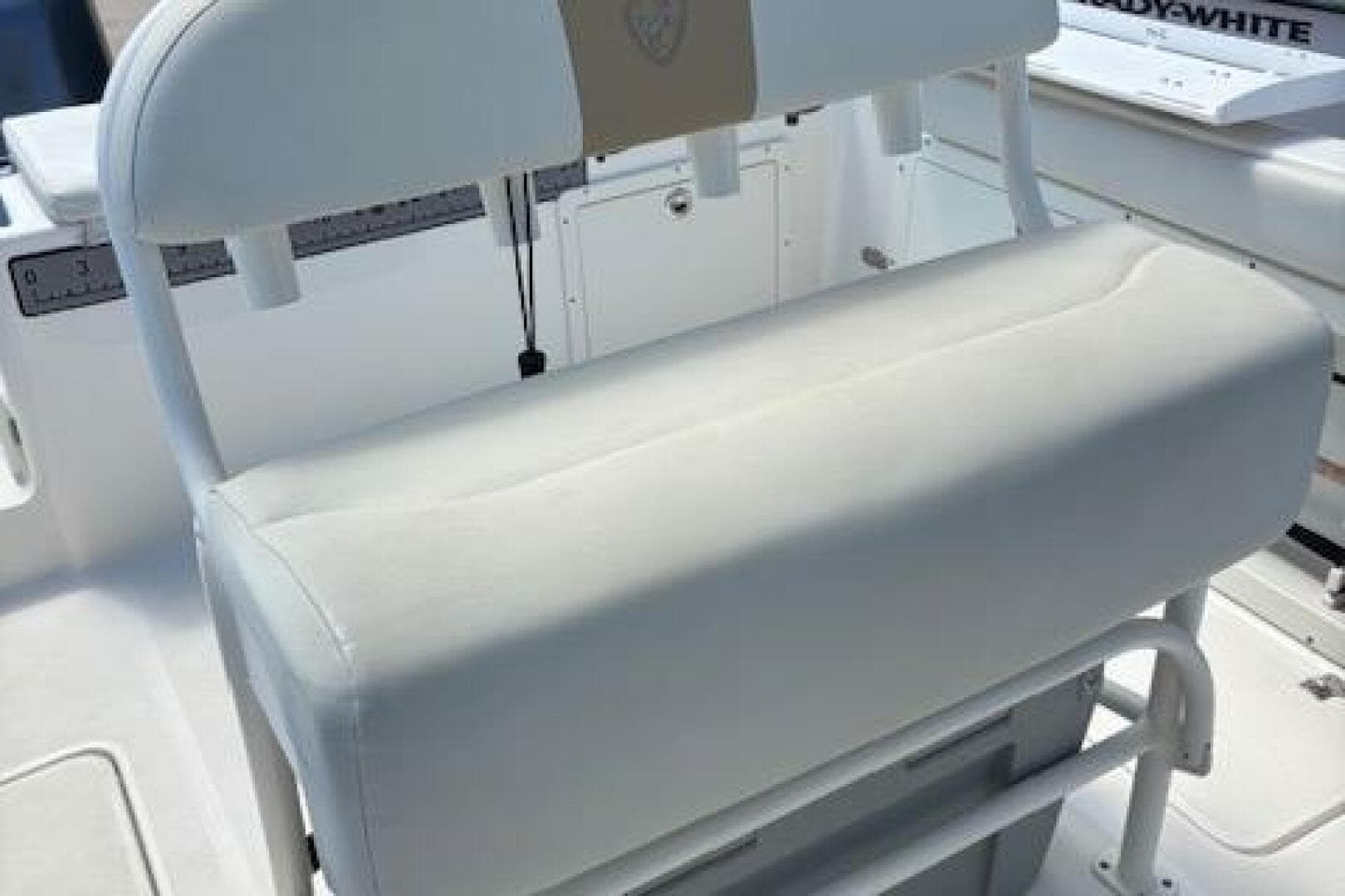 2018 Century 2600 Center Console boat seat, white upholstery, sturdy design.