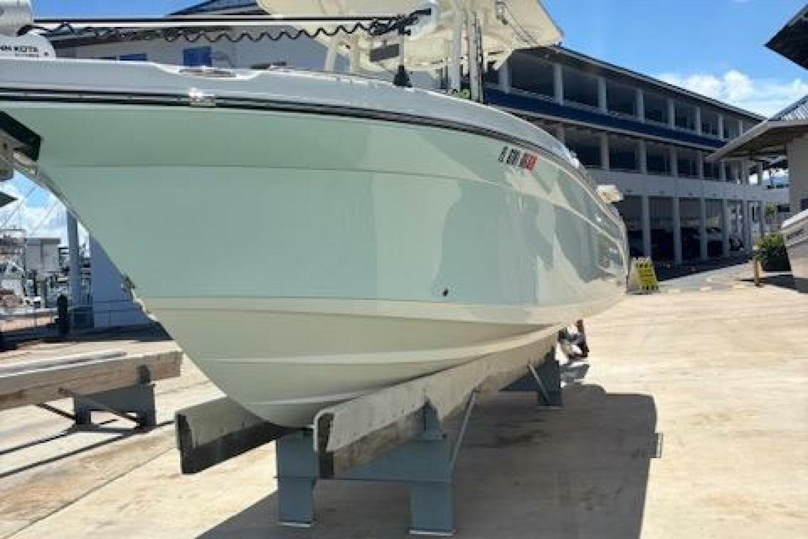 2018 Century 2600 Center Console boat on a dock, side view.