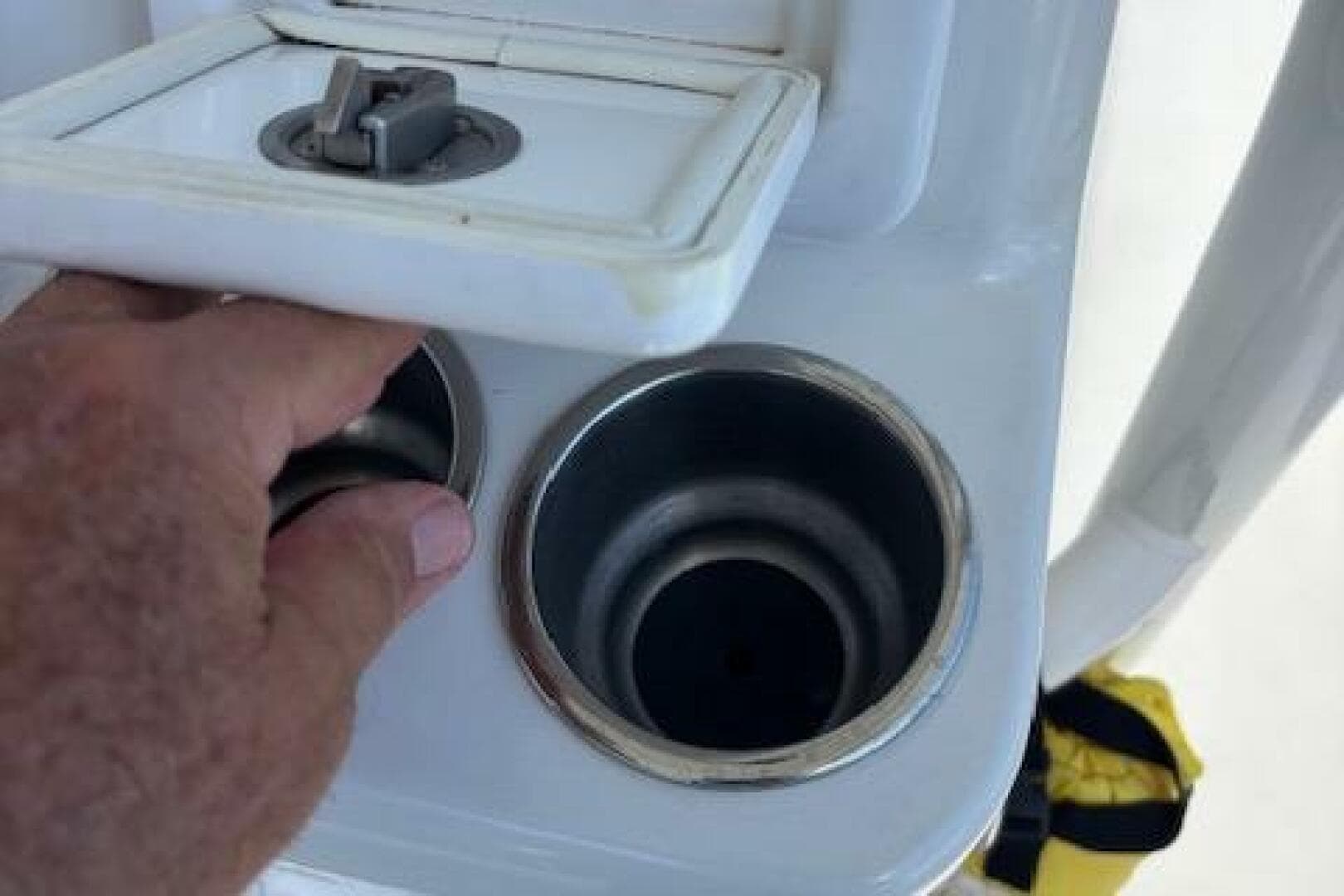 Hand accessing cup holders on 2018 Century 2600 Center Console boat.
