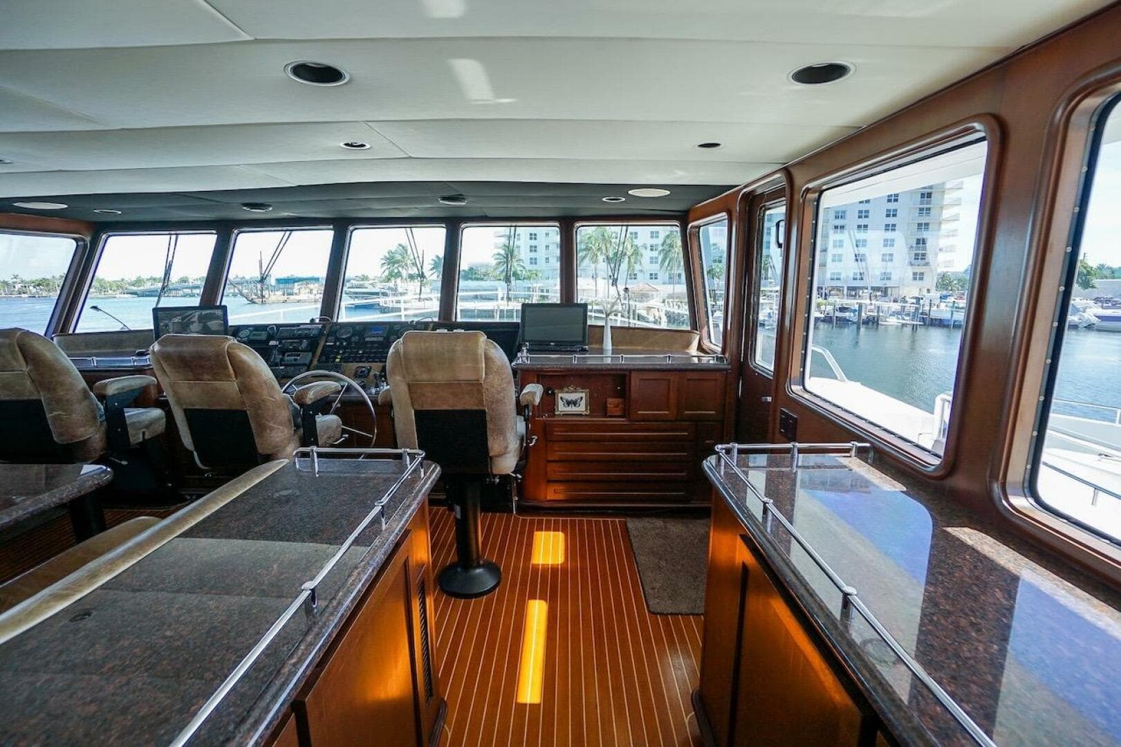 Luxurious interior of 1996 ABD 90 Explorer yacht with panoramic windows and plush seating.