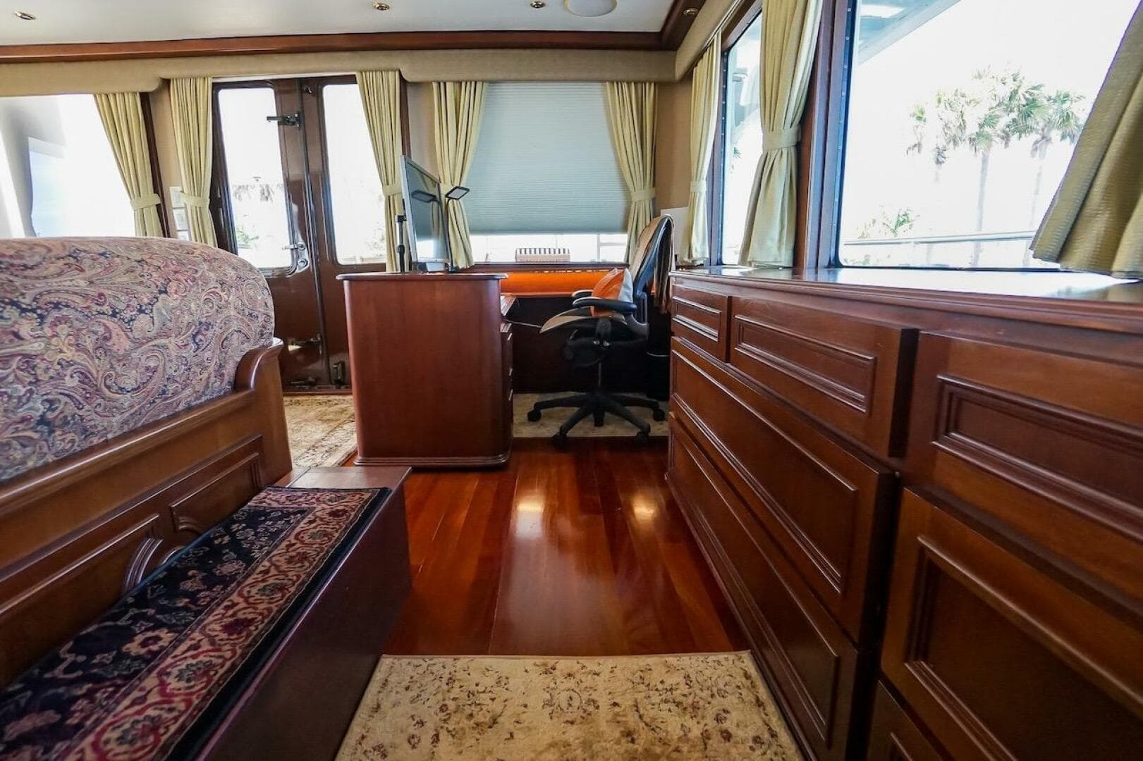 Luxurious interior of 1996 ABD 90 Explorer yacht with wooden furnishings and elegant decor.