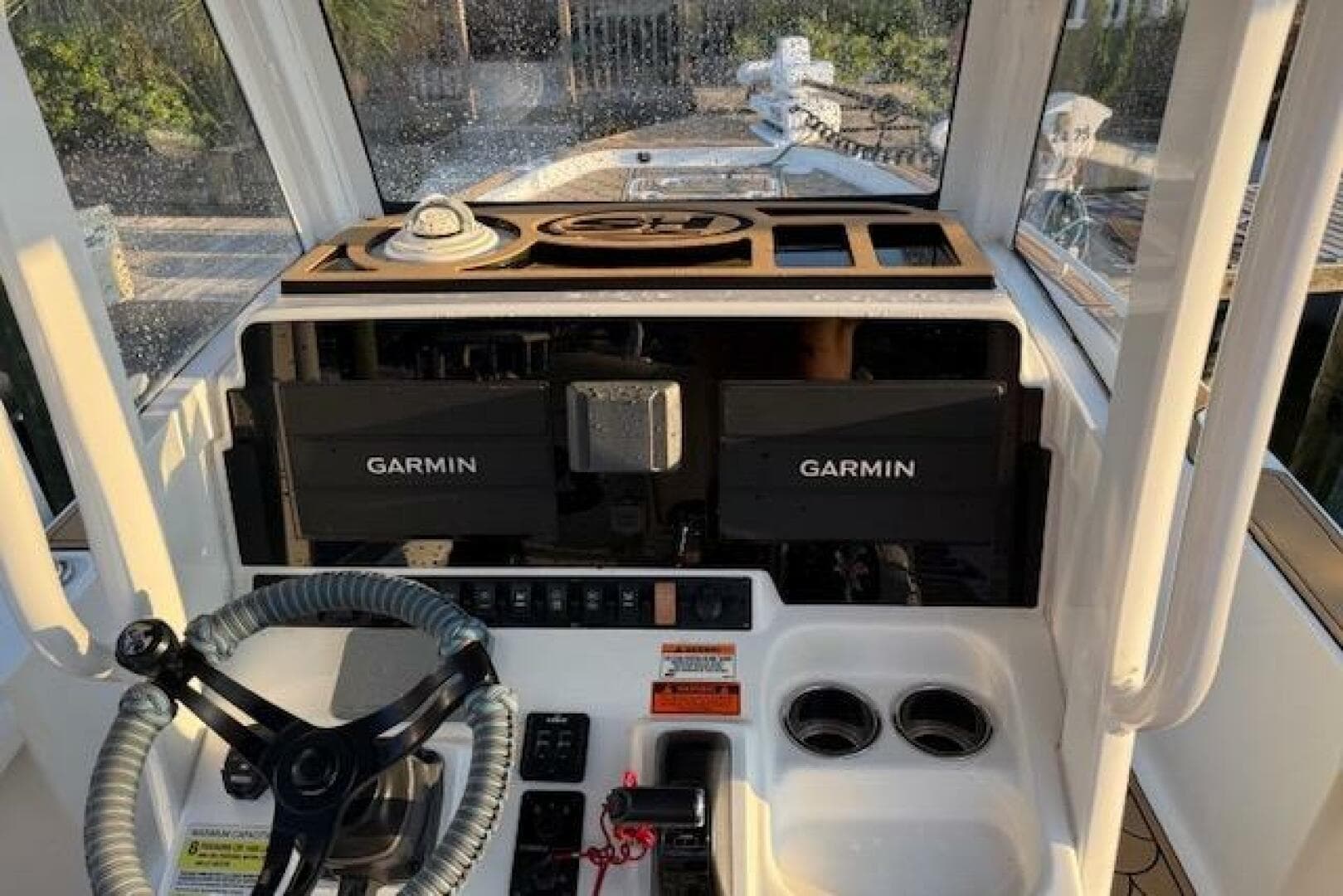 2018 Sea Hunt BX 25 FS boat dashboard with Garmin navigation systems and steering wheel.