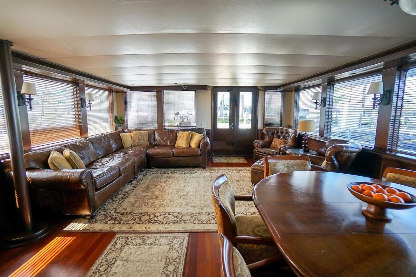 Luxurious interior of 1996 ABD 90 Explorer yacht with leather seating and elegant dining area.