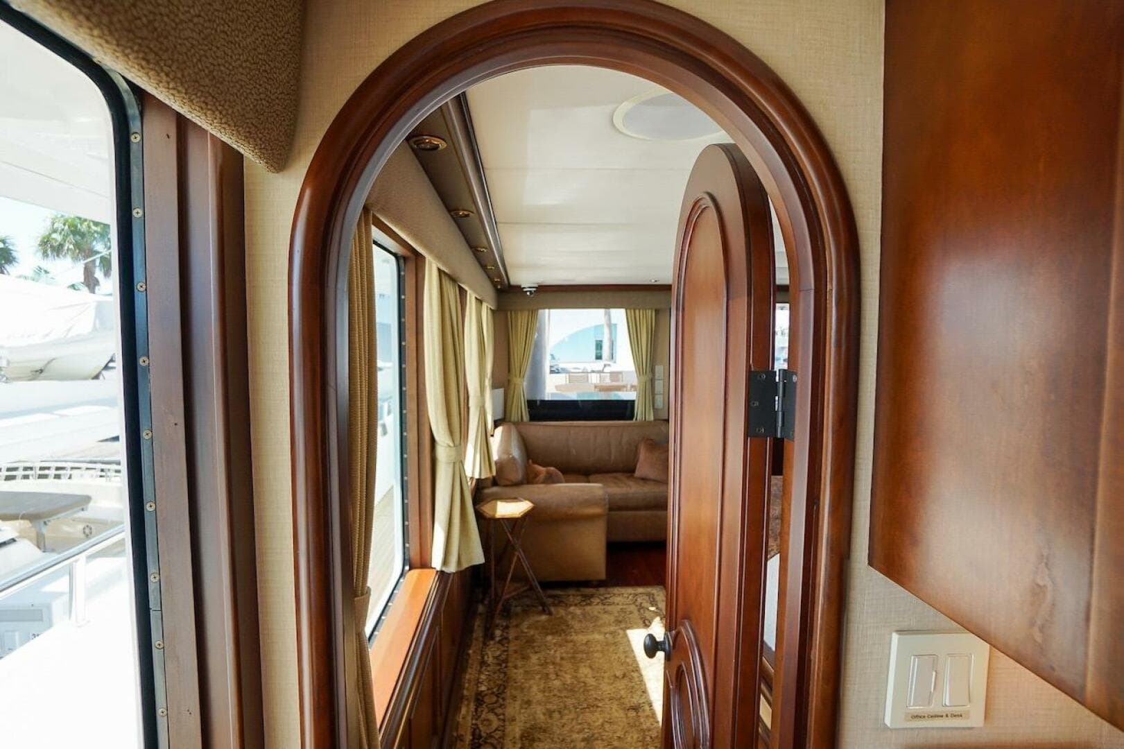 Interior of 1996 ABD 90 Explorer yacht with elegant wood finishes and cozy seating area.