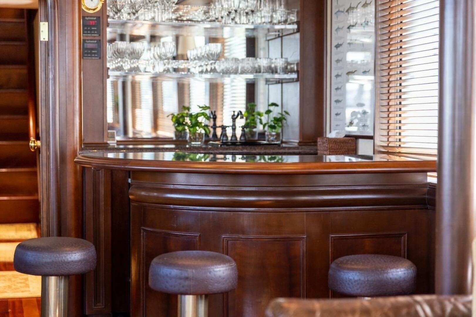 Luxurious dining area in 1996 ABD 90 Explorer yacht with TV and elegant decor.