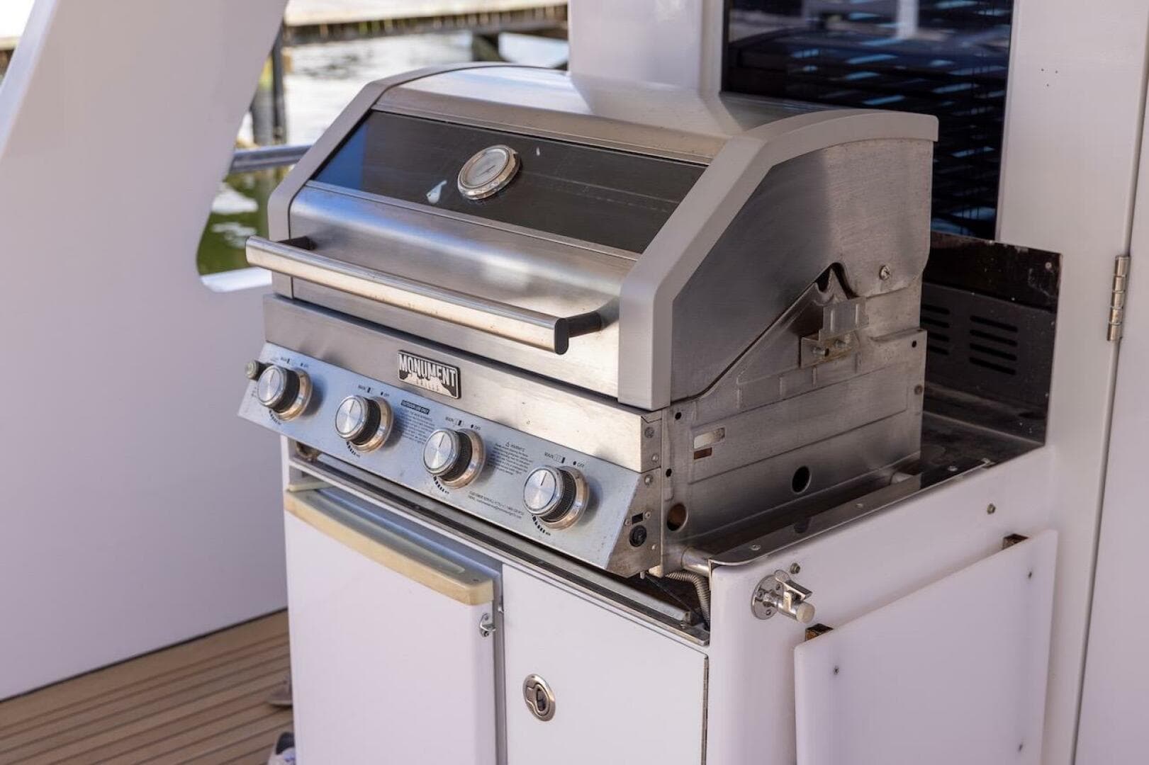 Stainless steel grill on ABD 90 Explorer yacht, 1996 model, with four control knobs.
