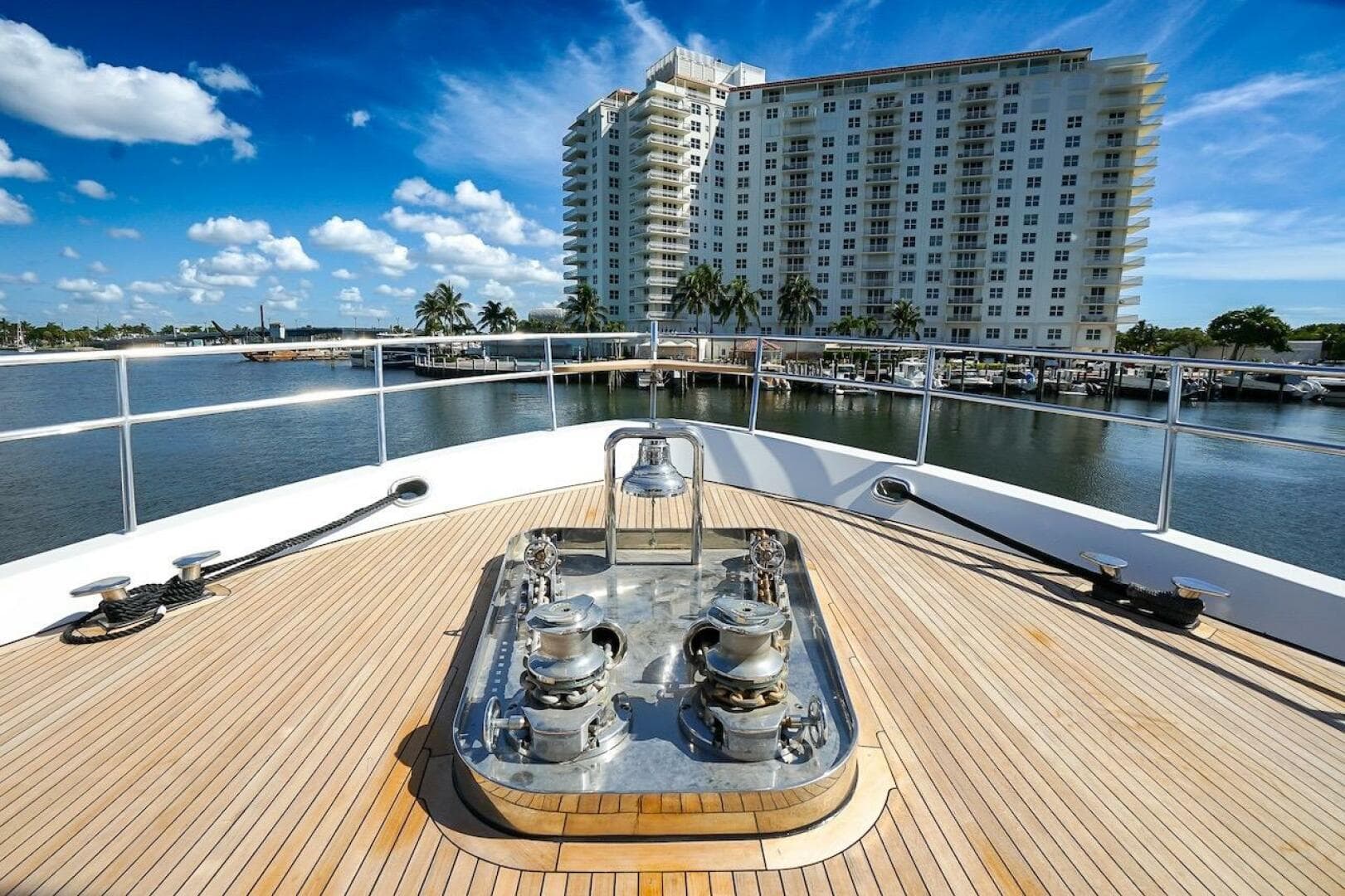 Luxurious 1996 ABD 90 Explorer yacht deck with striped seating and wooden table.