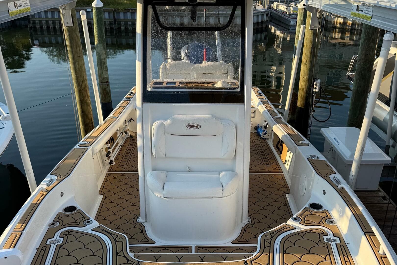 2018 Sea Hunt BX 25 FS boat interior with custom flooring, docked at marina.