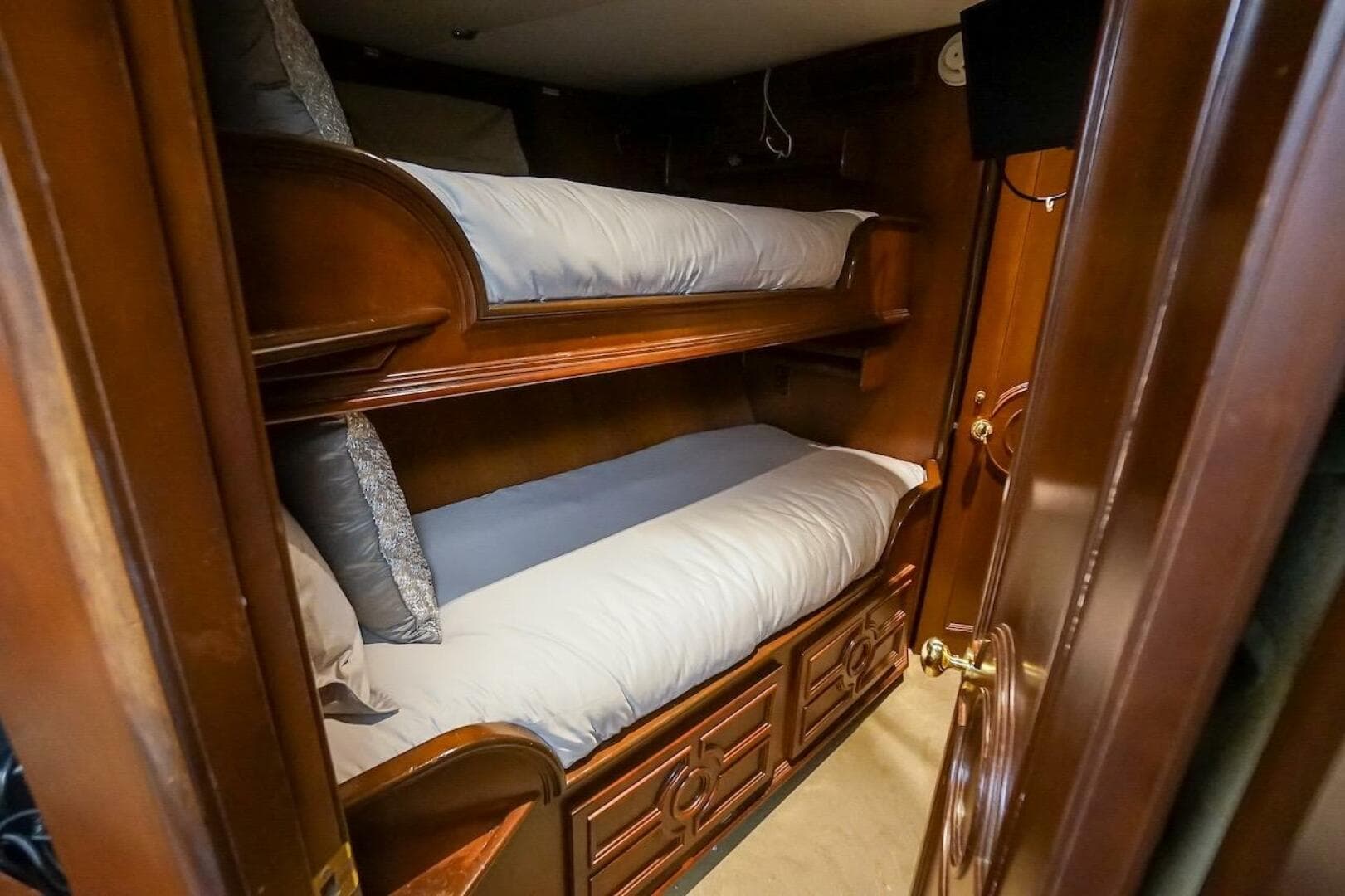 Bunk beds in a 1996 ABD 90 Explorer yacht cabin with wooden interior.