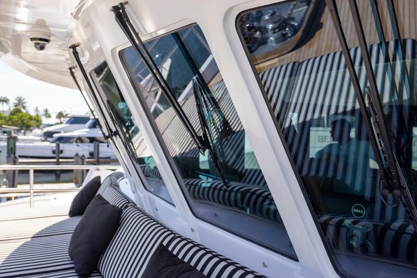 Luxury yacht with striped seating, featuring sleek windows and modern design elements.