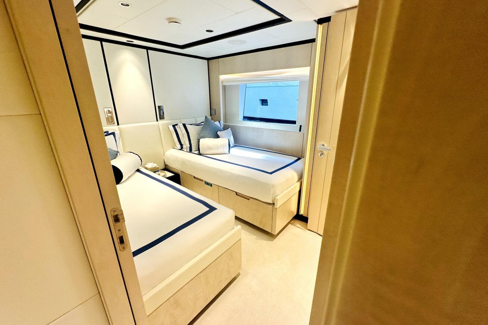 Luxurious cabin interior of 2023 Majesty 120 yacht with twin beds and modern decor.