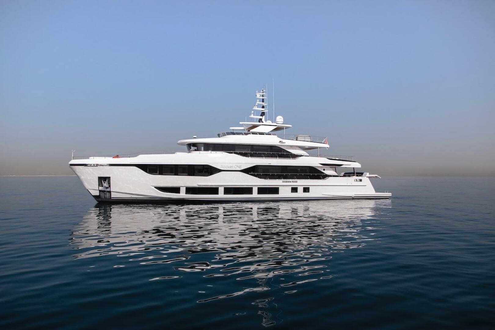 Luxurious 2023 Majesty 120 yacht on calm sea under clear blue sky.