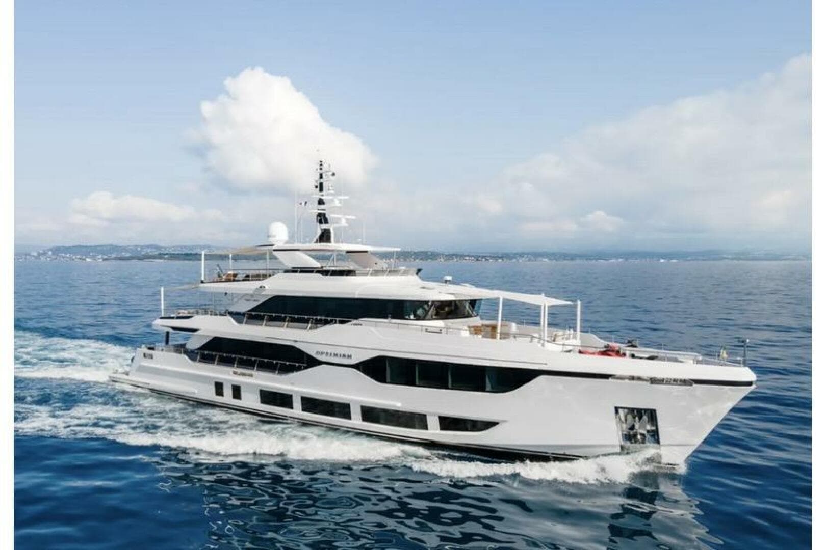 Luxurious 2023 Majesty 120 yacht cruising on open sea under clear skies.