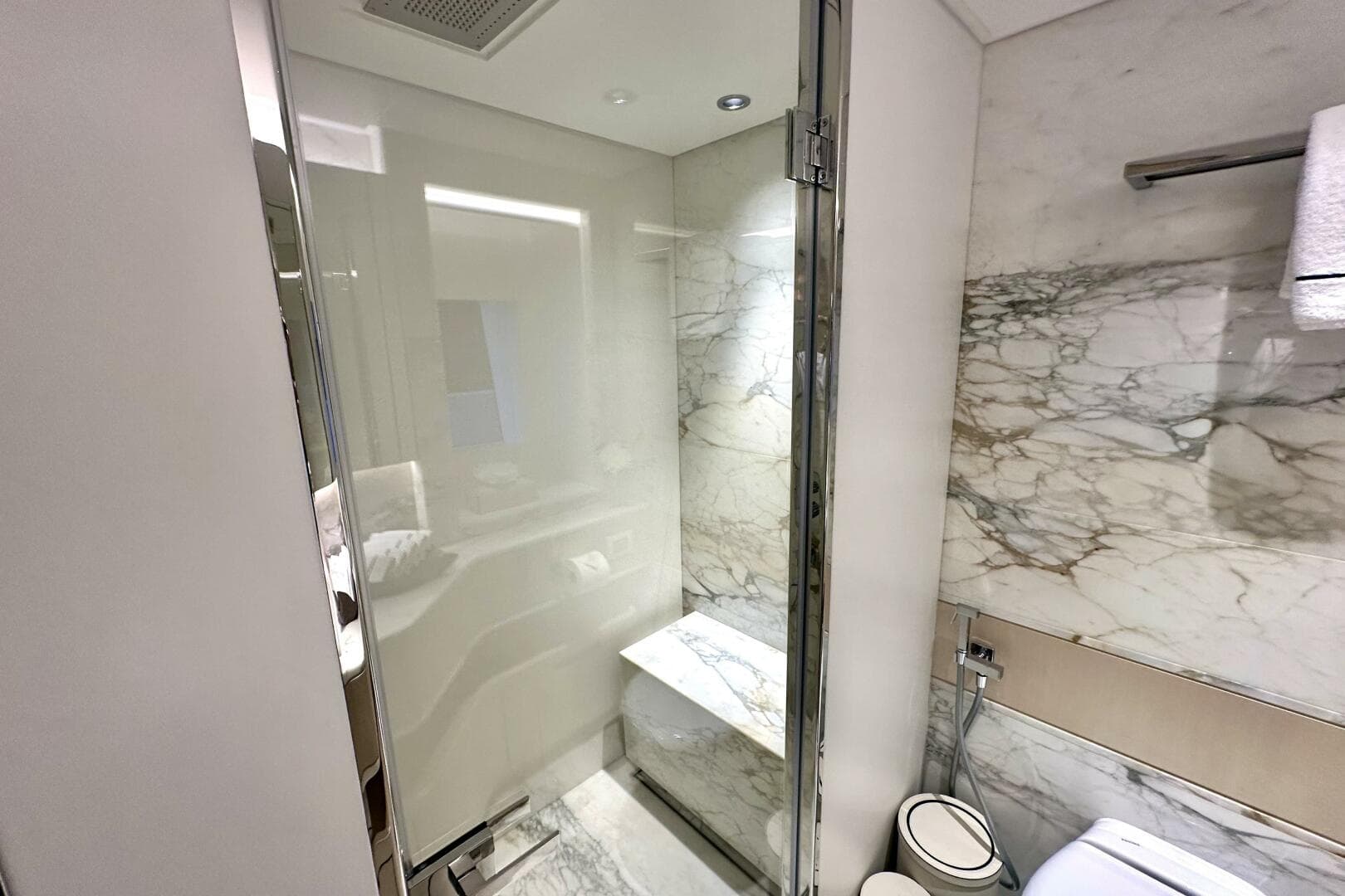 Luxurious marble bathroom in 2023 Majesty 120 yacht, featuring modern shower and elegant design.