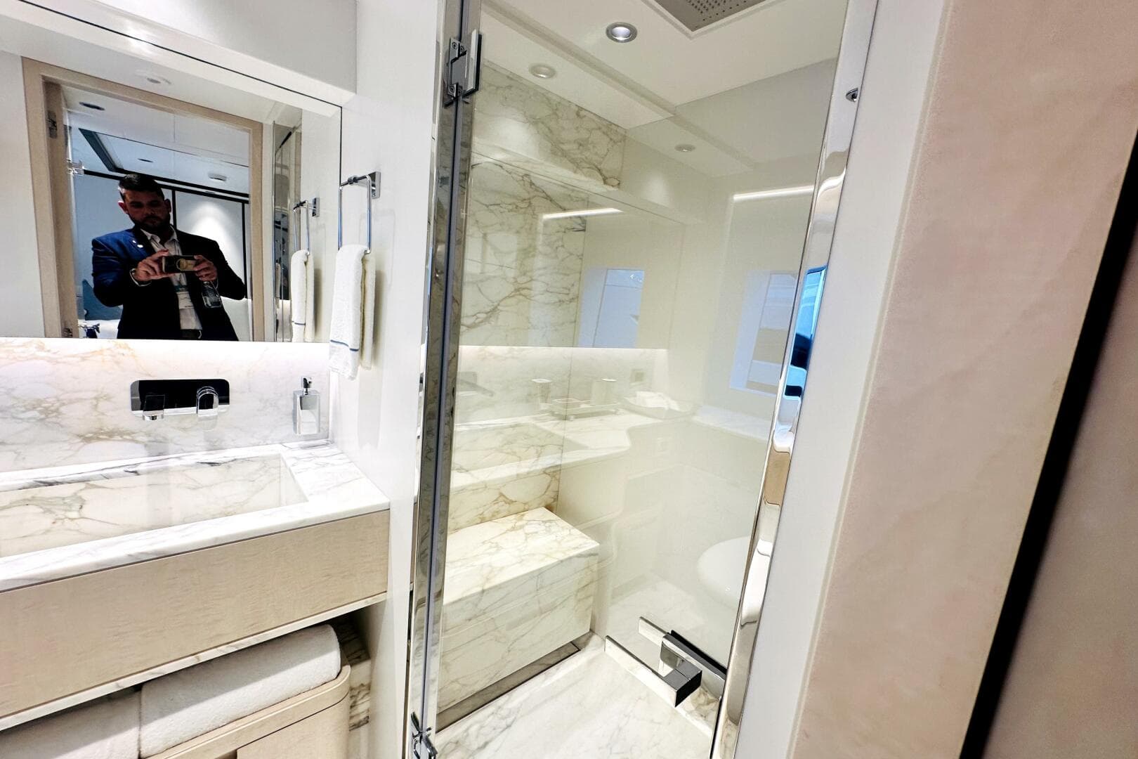 Luxurious bathroom in 2023 Majesty 120 yacht with marble accents and modern fixtures.