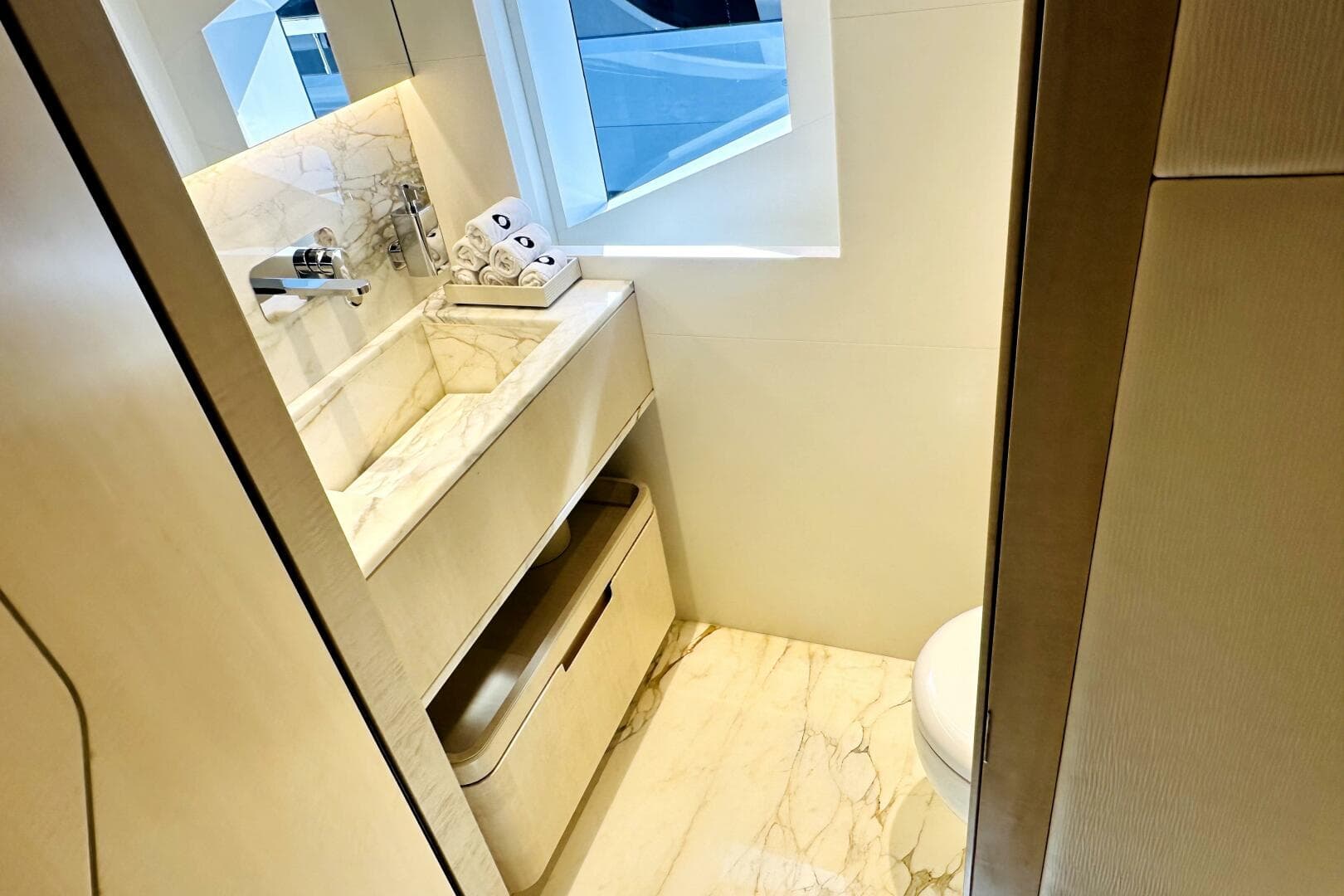 Luxurious bathroom in 2023 Majesty 120 yacht with marble sink and modern fixtures.