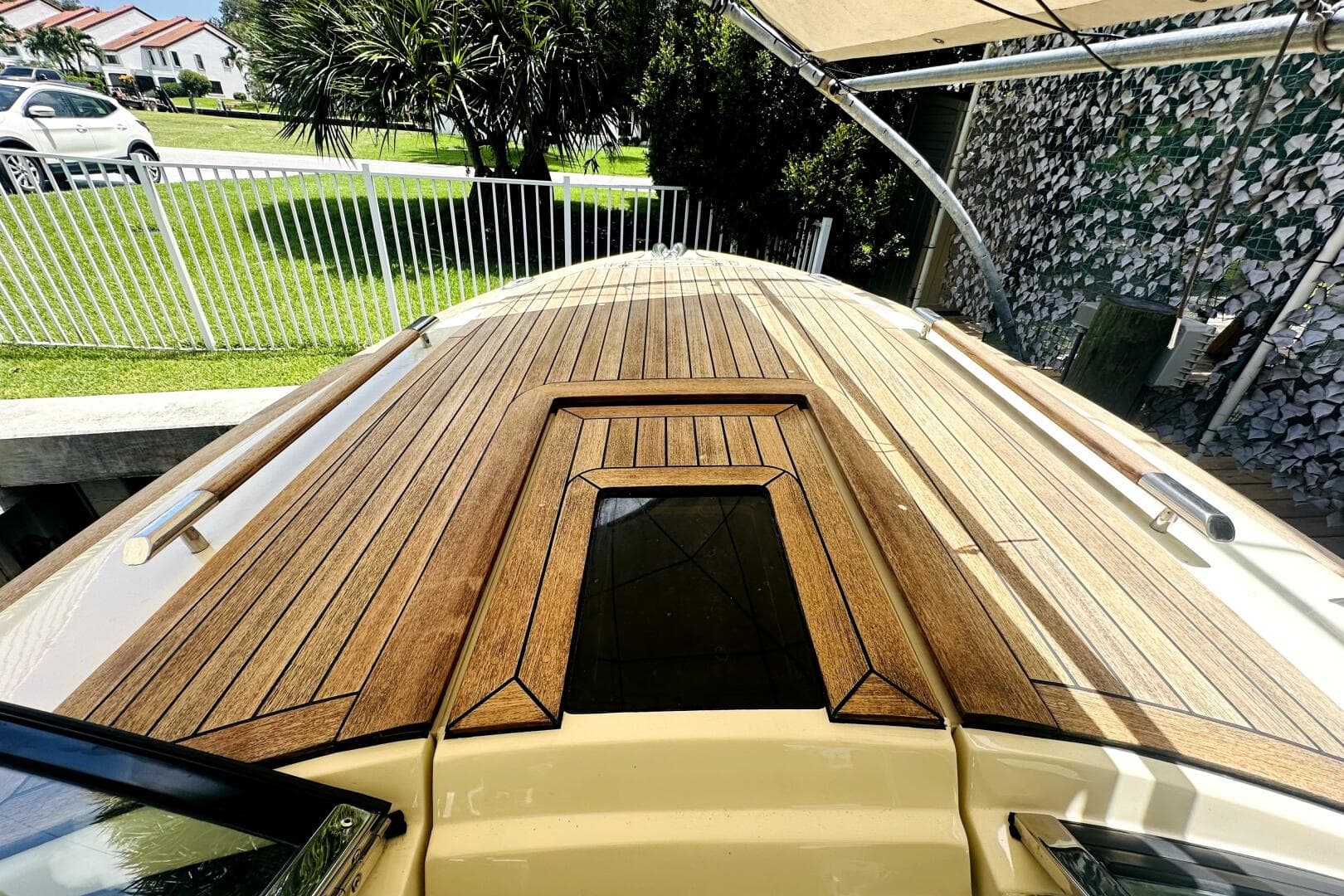 2013 Chris-Craft Corsair 22 boat with sleek wooden deck design.