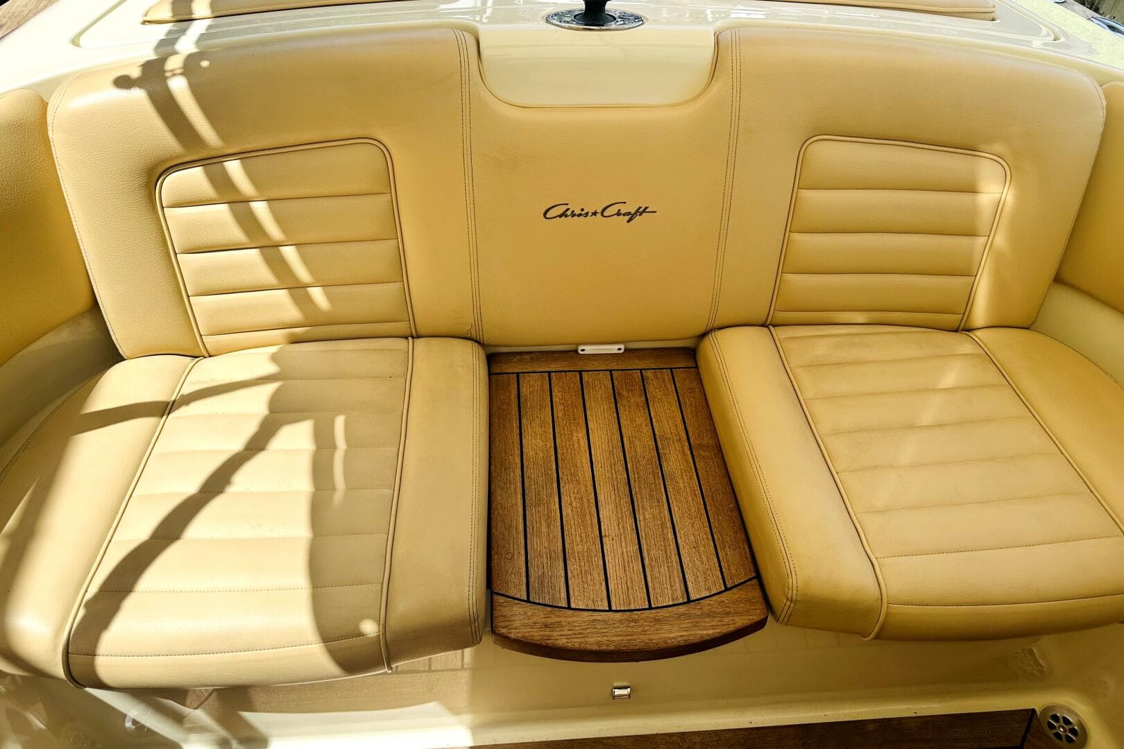 Luxurious tan leather seating on 2013 Chris-Craft Corsair 22 boat with wooden accents.