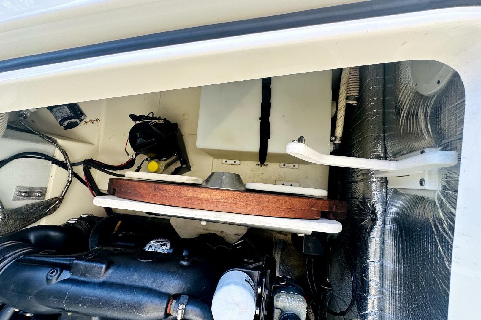 Engine compartment of a 2013 Chris-Craft Corsair 22 boat, showcasing mechanical components.
