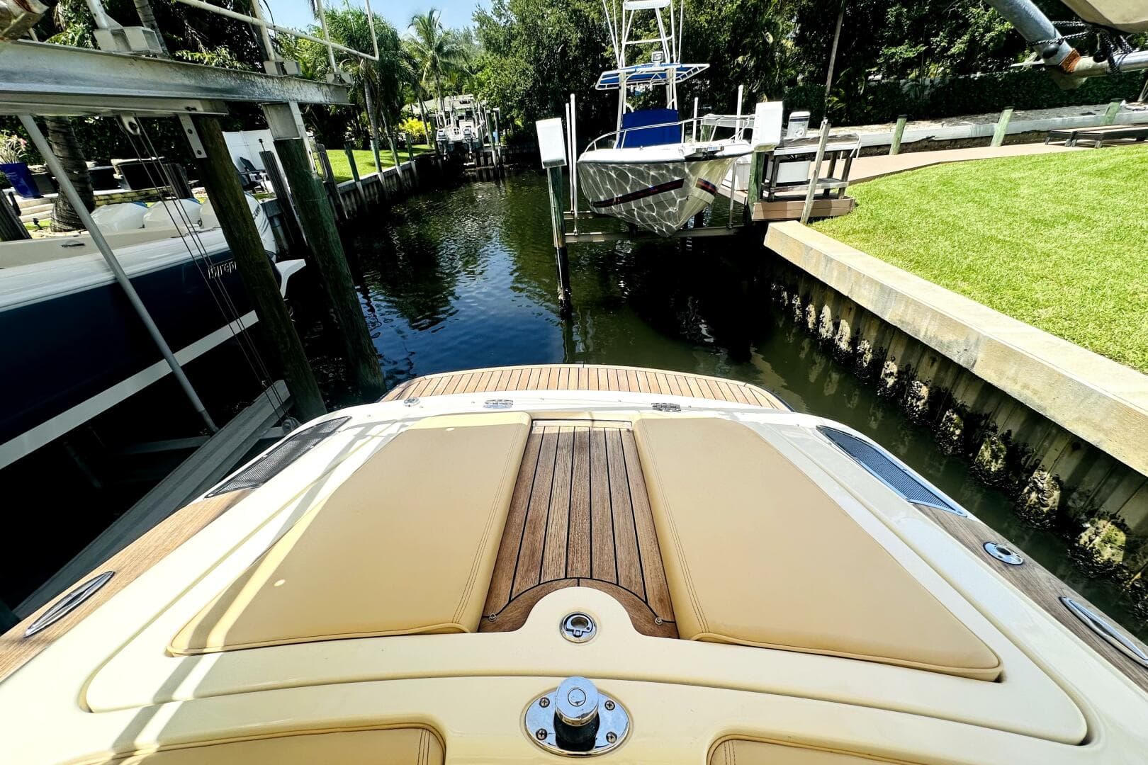 2013 Chris-Craft Corsair 22 docked in a serene canal setting.